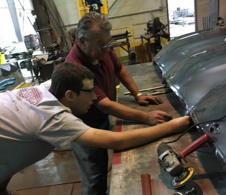 Alex—six feet ten inches of hands-on thinking—at work with the team.