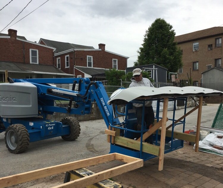 The hanging crew bringing the awning up to the second floor.